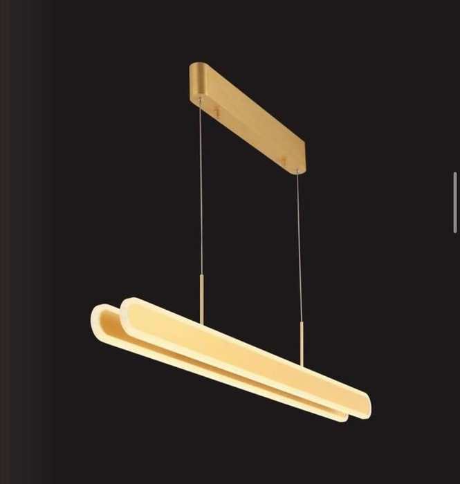 Brushed gold linear LED pendant light on a dark studio background
